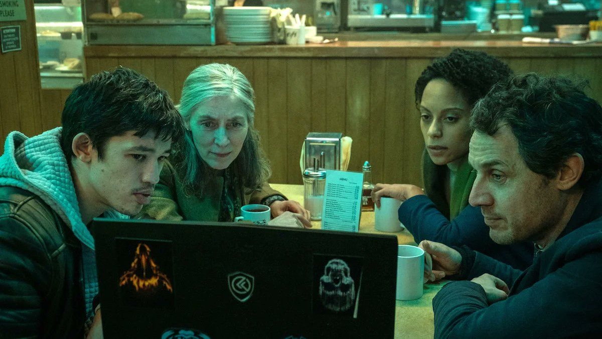 Catherine Standish and the Slow Horses in the diner, looking at a laptop screen.